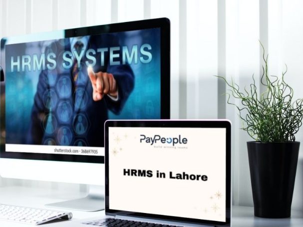 Professionals collaborating in a modern office using cloud-based hrms in lahore to improve engagement.
