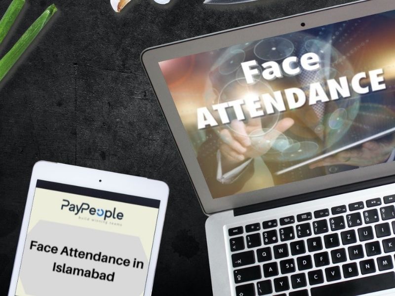 Modern office workers using biometric face attendance in Islamabad software on a wall-mounted tablet device.